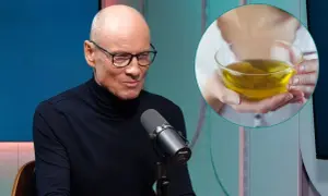 Mężczyzna w okularach i czarnym golfie rozmawia przy mikrofonie. Obok w okręgu widać dłonie trzymające miseczkę z żółtym płynem, być może podpowiedź, jak się odstresować.
