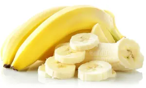 Kilka dojrzałych bananów, jeden obrany i pokrojony w plastry. Banan na biegunkę to naturalny sposób na złagodzenie dolegliwości.